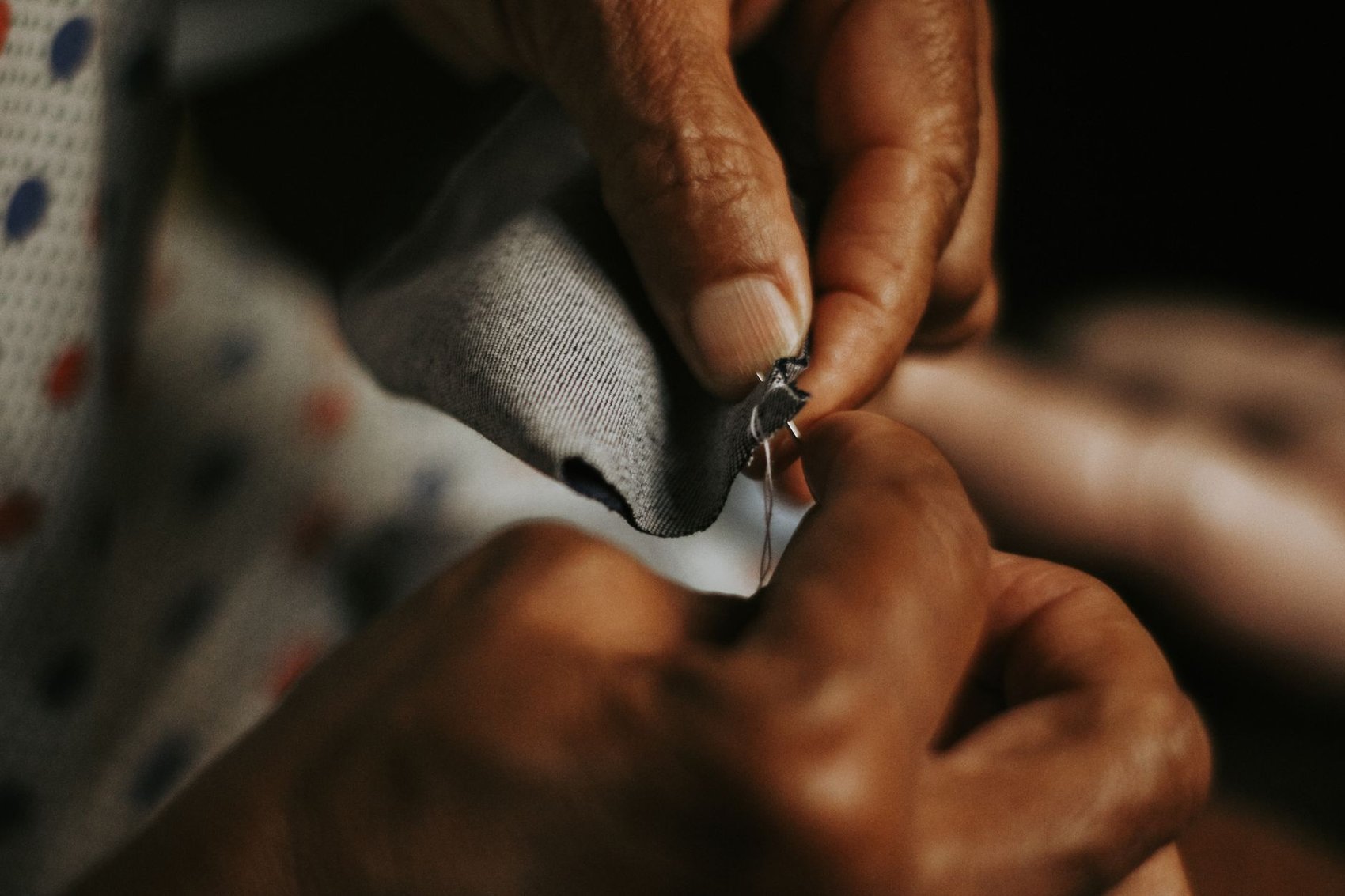 Tailor at work stitching fabric